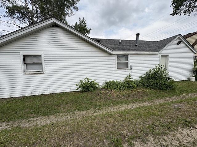 2841 10th St, Rockford, IL 61108 - view of side of property featuring a shingled roof and a lawn