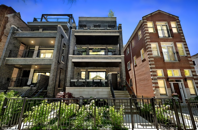 1469 W Byron St Unit 2, Chicago, IL 60613 - view of property with a balcony, brick siding, and stairs