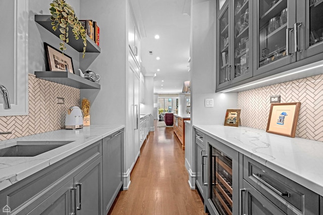 1469 W Byron St Unit 2, Chicago, IL 60613 - bar area with decorative backsplash, wine cooler, light wood finished floors, and recessed lighting