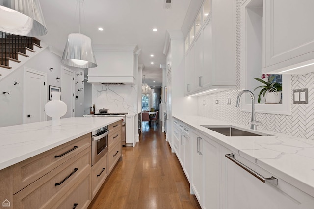 1469 W Byron St Unit 2, Chicago, IL 60613 - kitchen with tasteful backsplash, light wood-style flooring, appliances with stainless steel finishes, recessed lighting, and light stone countertops