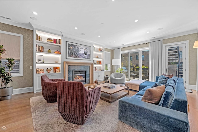 1469 W Byron St Unit 2, Chicago, IL 60613 - living room with light wood finished floors, a fireplace, recessed lighting, built in features, and crown molding