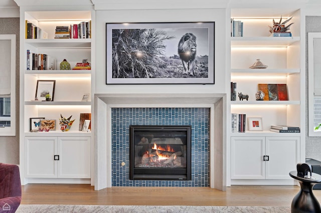 1469 W Byron St Unit 2, Chicago, IL 60613 - detailed view of built in shelves, a tile fireplace, and wood finished floors