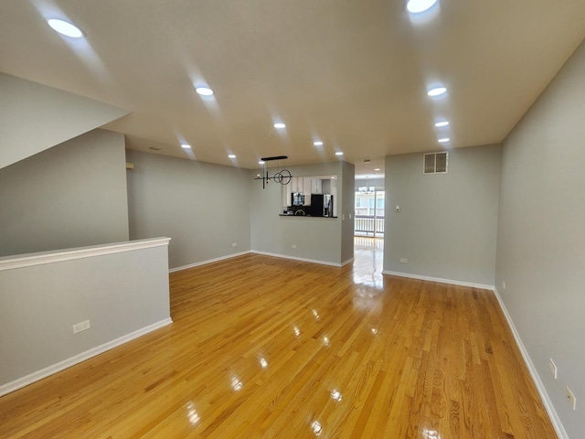 746 River Mill Parkway, Wheeling, IL 60090 - unfurnished living room with light wood-style flooring and recessed lighting