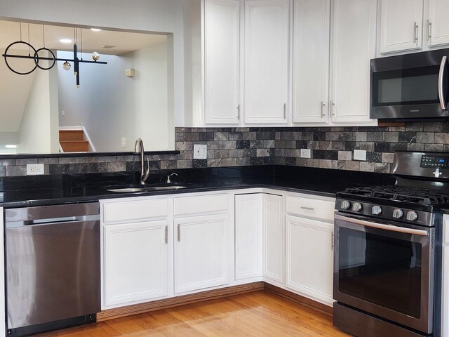 746 River Mill Parkway, Wheeling, IL 60090 - kitchen featuring stainless steel appliances, light wood-style floors, and white cabinets