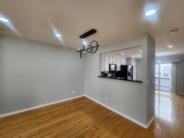 746 River Mill Parkway, Wheeling, IL 60090 - unfurnished dining area with wood finished floors, recessed lighting, and a chandelier