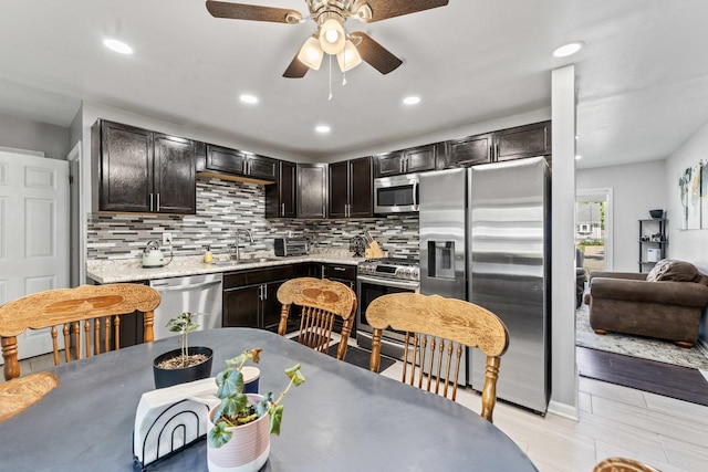 2110 Joanna Ave, Zion, IL 60099 - kitchen with appliances with stainless steel finishes, backsplash, ceiling fan, recessed lighting, and light countertops