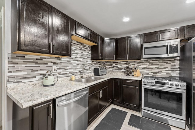 2110 Joanna Ave, Zion, IL 60099 - kitchen featuring appliances with stainless steel finishes, tasteful backsplash, dark brown cabinetry, recessed lighting, and light stone counters