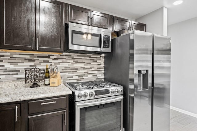 2110 Joanna Ave, Zion, IL 60099 - kitchen with stainless steel appliances, dark brown cabinets, and decorative backsplash