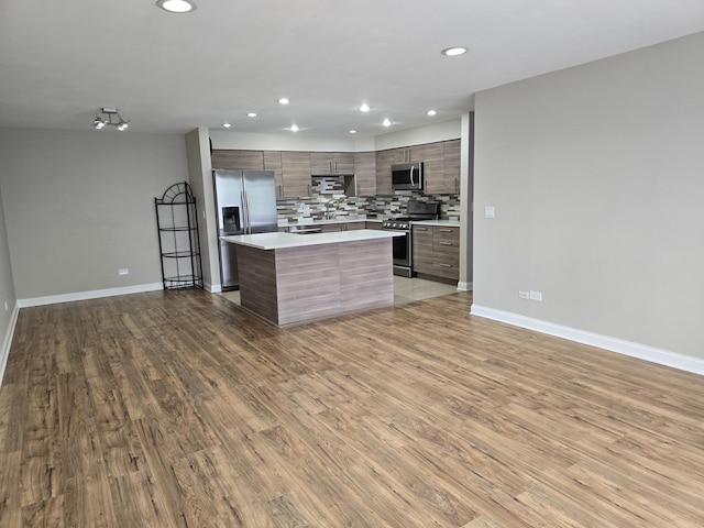 1441 E Thacker St Unit 501, Des Plaines, IL 60016 - kitchen featuring stainless steel appliances, modern cabinets, wood finished floors, light countertops, and tasteful backsplash