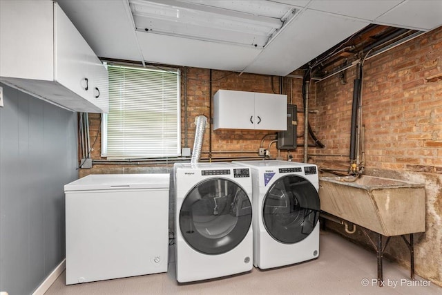 8920 Mcvicker Ave, Morton Grove, IL 60053 - laundry area with washing machine and dryer, cabinet space, electric panel, and brick wall