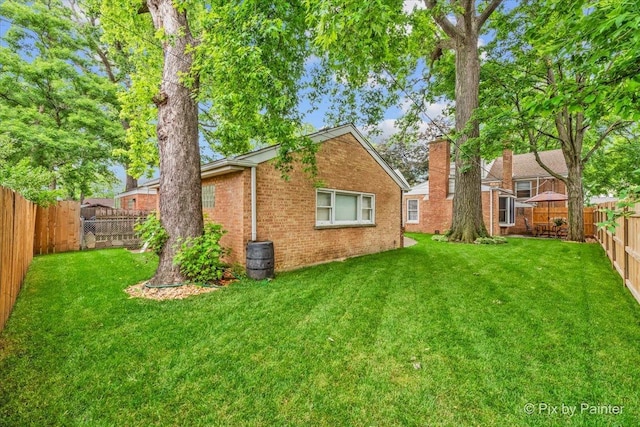 8920 Mcvicker Ave, Morton Grove, IL 60053 - rear view of property with brick siding, a chimney, and a fenced backyard