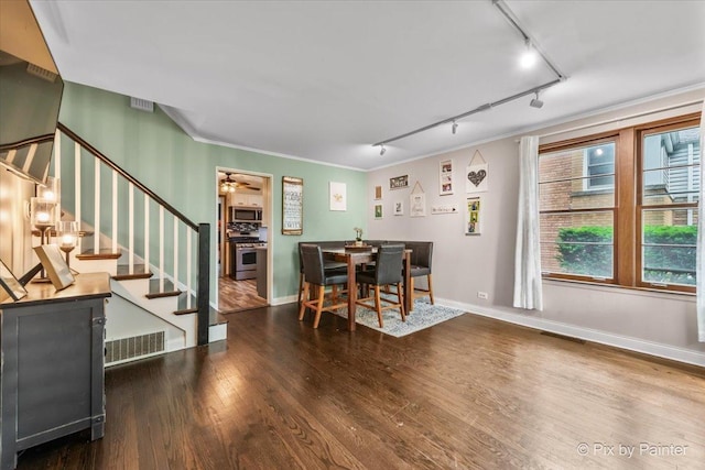 8920 Mcvicker Ave, Morton Grove, IL 60053 - dining room featuring rail lighting, wood finished floors, stairway, a ceiling fan, and crown molding