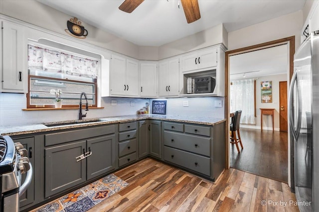 8920 Mcvicker Ave, Morton Grove, IL 60053 - kitchen featuring gray cabinetry, stainless steel fridge, ceiling fan, range, and backsplash