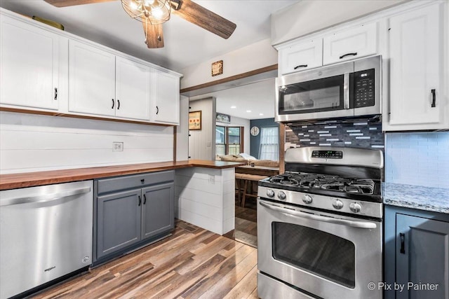 8920 Mcvicker Ave, Morton Grove, IL 60053 - kitchen with appliances with stainless steel finishes, gray cabinetry, ceiling fan, white cabinetry, and light wood finished floors