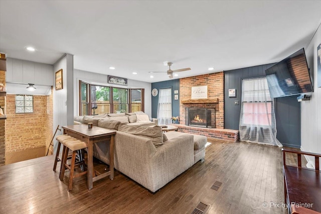 8920 Mcvicker Ave, Morton Grove, IL 60053 - living area featuring a brick fireplace, a ceiling fan, hardwood / wood-style floors, brick wall, and recessed lighting