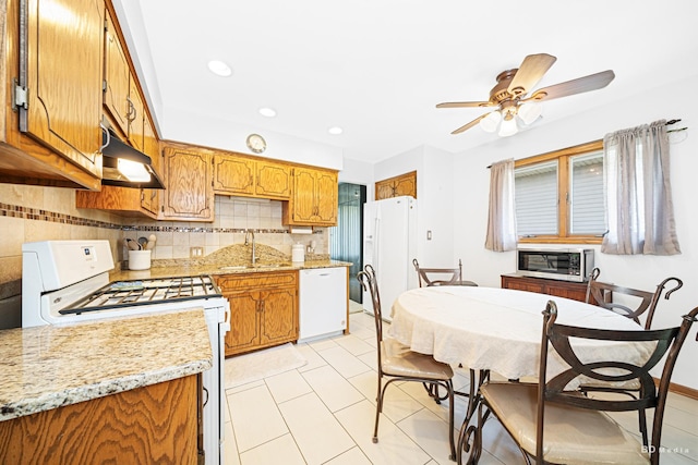 14224 Karlov Ave, Crestwood, IL 60418 - kitchen featuring white appliances, under cabinet range hood, backsplash, ceiling fan, and brown cabinetry