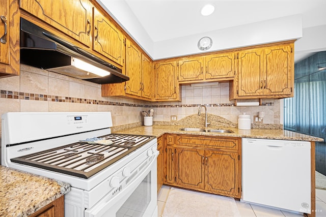 14224 Karlov Ave, Crestwood, IL 60418 - kitchen featuring white appliances, under cabinet range hood, light tile patterned flooring, backsplash, and brown cabinets
