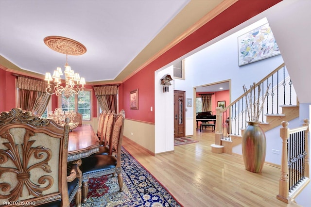 22450 Autumn Dr, Frankfort, IL 60423 - dining area with a chandelier, wood finished floors, stairway, and crown molding