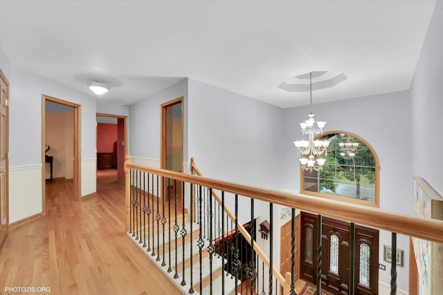 22450 Autumn Dr, Frankfort, IL 60423 - hallway featuring an upstairs landing, a chandelier, light wood-style flooring, and a wainscoted wall