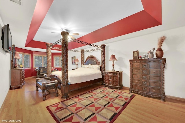 22450 Autumn Dr, Frankfort, IL 60423 - bedroom featuring wood finished floors, a tray ceiling, and a ceiling fan