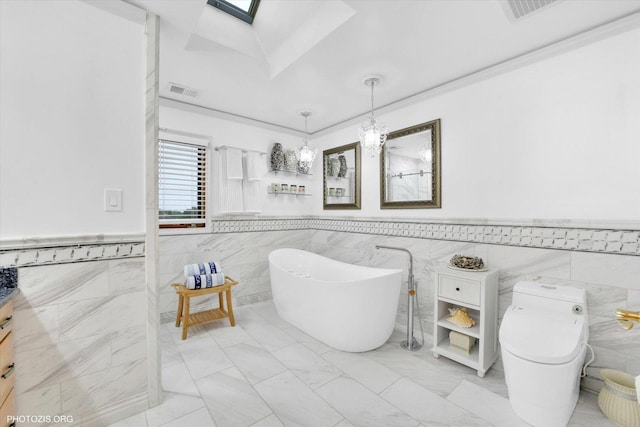 22450 Autumn Dr, Frankfort, IL 60423 - full bath featuring tile walls, a soaking tub, a wainscoted wall, a skylight, and a chandelier