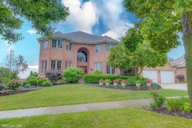 22450 Autumn Dr, Frankfort, IL 60423 - view of front of home featuring concrete driveway, a front lawn, brick siding, and a garage