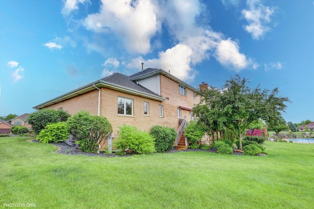 22450 Autumn Dr, Frankfort, IL 60423 - rear view of property with a yard, brick siding, a chimney, and stairs