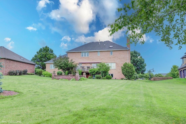 22450 Autumn Dr, Frankfort, IL 60423 - back of house featuring a chimney, a yard, and brick siding