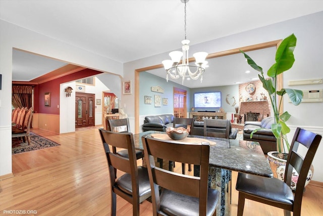 22450 Autumn Dr, Frankfort, IL 60423 - dining area featuring a chandelier, light wood-type flooring, and wainscoting