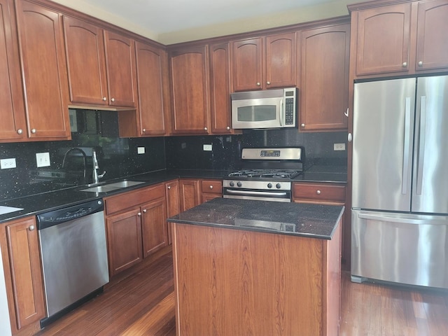 3144 Taunton St Unit 3144, Elgin, IL 60124 - kitchen featuring stainless steel appliances, dark wood-type flooring, dark stone counters, backsplash, and a center island