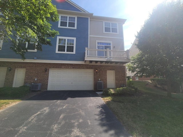 3144 Taunton St Unit 3144, Elgin, IL 60124 - rear view of property featuring asphalt driveway, brick siding, and a garage
