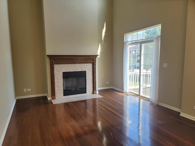 3144 Taunton St Unit 3144, Elgin, IL 60124 - unfurnished living room with wood finished floors, a towering ceiling, and a fireplace
