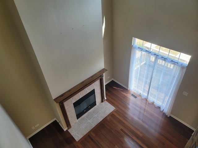 3144 Taunton St Unit 3144, Elgin, IL 60124 - unfurnished living room with wood finished floors, a tile fireplace, and a high ceiling