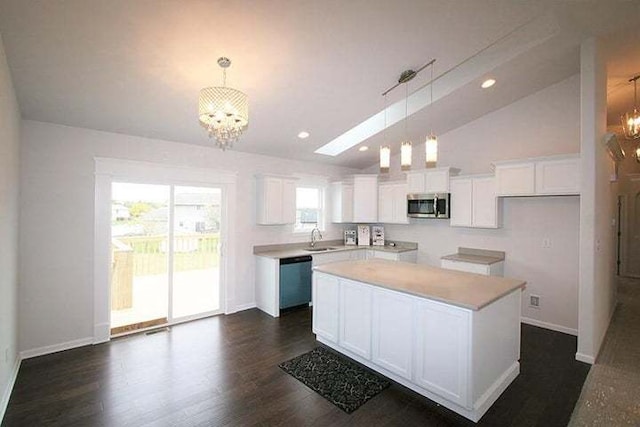 8301 Dylan Dr, Merrillville, IN 46410 - kitchen with stainless steel microwave, a chandelier, vaulted ceiling, dishwasher, and white cabinets