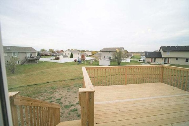 8301 Dylan Dr, Merrillville, IN 46410 - wooden deck featuring a residential view, a storage unit, and a yard