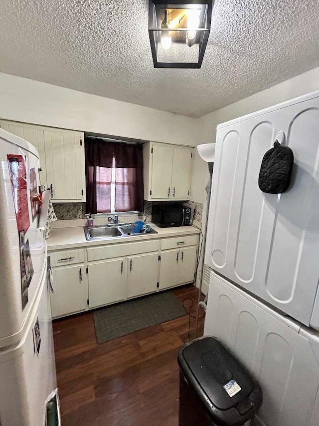 2251 Grandview Ave, Crest Hill, IL 60403 - kitchen featuring freestanding refrigerator, dark wood-type flooring, light countertops, a textured ceiling, and black microwave