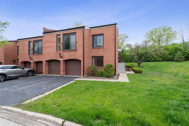 2S570 Patrick Henry Sq Unit 119, Oak Brook, IL 60523 - view of property with driveway, an attached garage, a front lawn, and brick siding