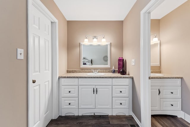 2S570 Patrick Henry Sq Unit 119, Oak Brook, IL 60523 - bathroom featuring wood finished floors and vanity