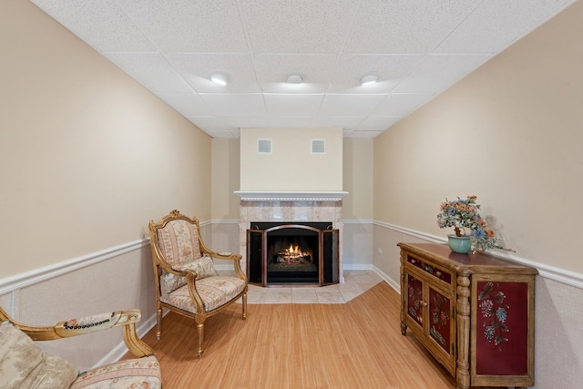 2S570 Patrick Henry Sq Unit 119, Oak Brook, IL 60523 - living area with a paneled ceiling, wood finished floors, and a fireplace