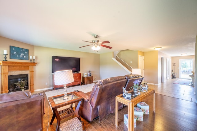 1715 W River St Unit 1715, Dixon, IL 61021 - living room featuring stairs, a glass covered fireplace, ceiling fan, and wood finished floors