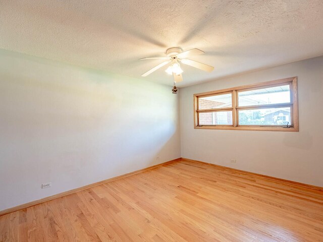 6052 W 128th St, Palos Heights, IL 60463 - unfurnished room with light wood-style floors, ceiling fan, and a textured ceiling