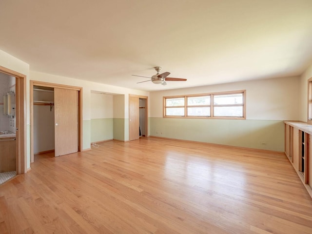 6052 W 128th St, Palos Heights, IL 60463 - unfurnished bedroom featuring light wood-style flooring, multiple closets, and a ceiling fan