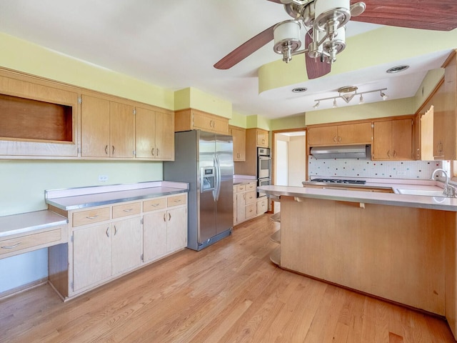 6052 W 128th St, Palos Heights, IL 60463 - kitchen featuring stainless steel appliances, under cabinet range hood, light countertops, a peninsula, and light wood-style floors