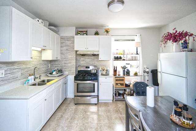 2834 S Union Ave, Chicago, IL 60616 - kitchen featuring gas range, freestanding refrigerator, tasteful backsplash, and white cabinets