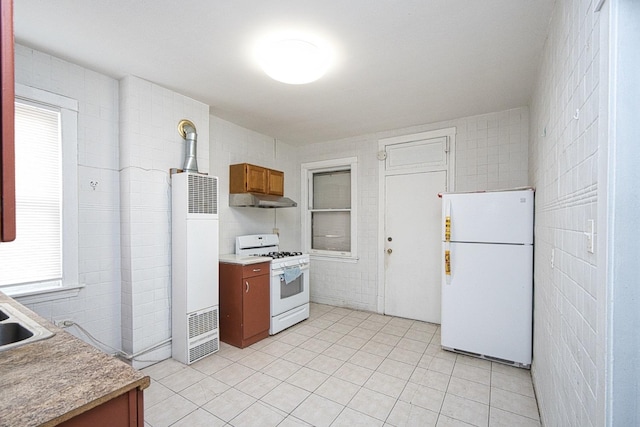 2834 S Union Ave, Chicago, IL 60616 - kitchen with white appliances, a heating unit, under cabinet range hood, brown cabinetry, and light tile patterned floors