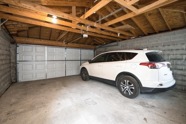 2834 S Union Ave, Chicago, IL 60616 - garage featuring a garage door opener and concrete block wall