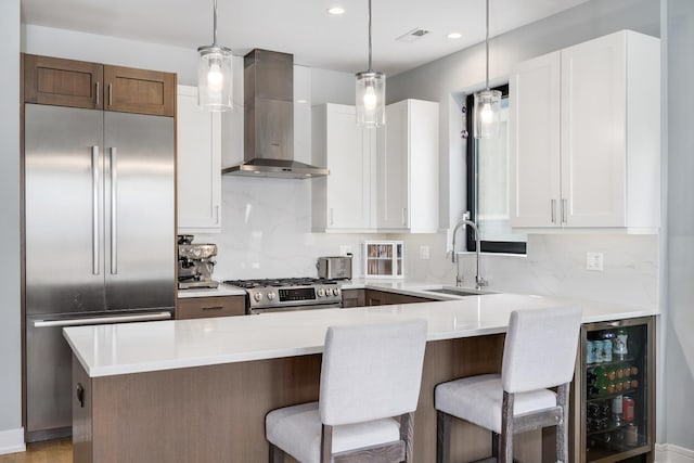 1011 N Winchester Ave Unit 2, Chicago, IL 60622 - kitchen with wall chimney range hood, appliances with stainless steel finishes, beverage cooler, tasteful backsplash, and recessed lighting
