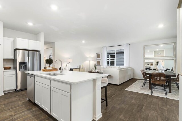 2281 Redwood Trl, Wonder Lake, IL 60097 - kitchen featuring appliances with stainless steel finishes, open floor plan, white cabinetry, dark wood-style floors, and recessed lighting