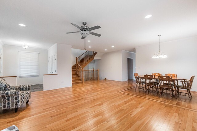 3723 N Nordica Ave, Chicago, IL 60634 - living room with light wood-type flooring, ceiling fan, crown molding, recessed lighting, and stairs