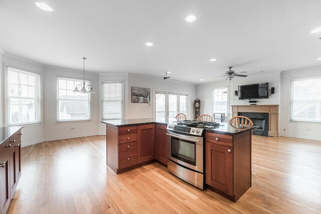3723 N Nordica Ave, Chicago, IL 60634 - kitchen featuring stainless steel range with gas cooktop, a high end fireplace, light wood-style flooring, recessed lighting, and crown molding